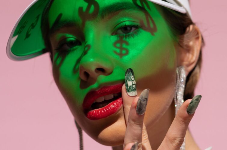 Model with a unique green manicure and dollar-themed makeup, at Armani Nail Boutique, the best in the heart of Vancouver.