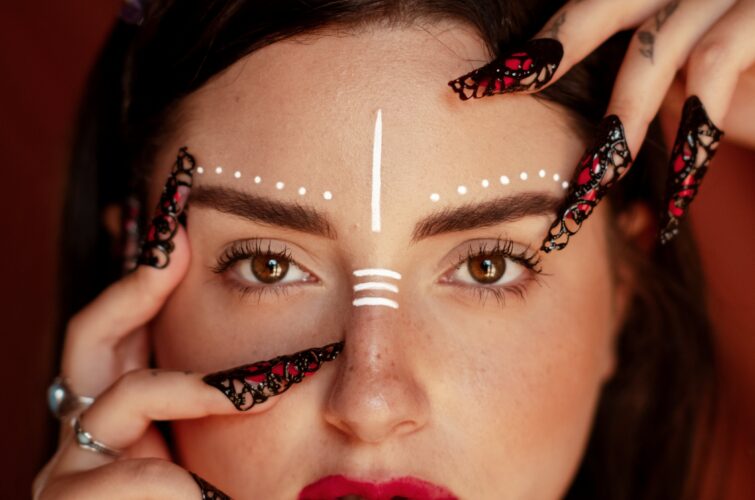 Model with creative black and red nail designs and makeup, at Armani Nail Boutique, the best in the heart of Vancouver.