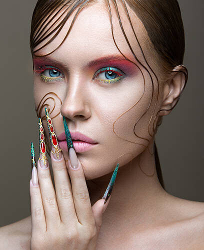 Model showcasing unique, jeweled nail designs at Armani Nail Boutique, located in the heart of Vancouver.